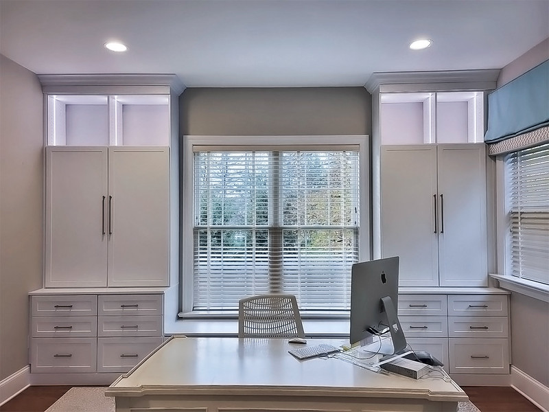 Custom desk space with built-in storage cabinets in the background